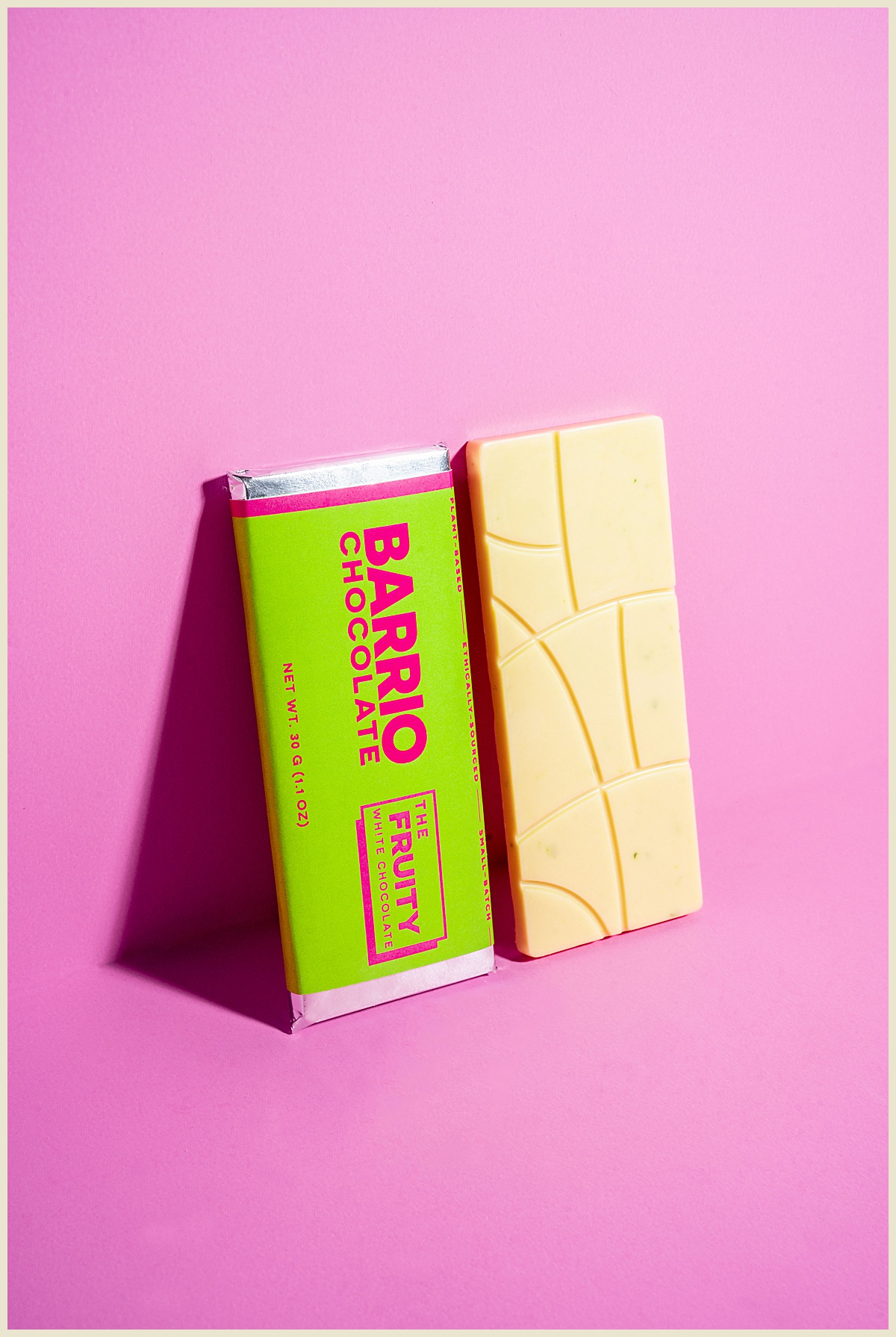 Product photography of chocolate bar in Greenville, South Carolina on pink backdrop