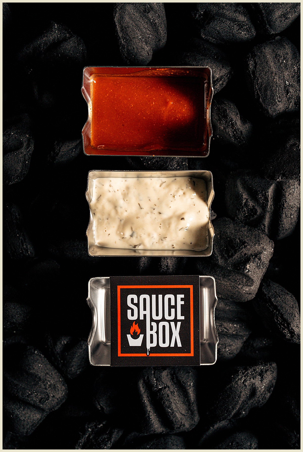 Greenville, South Carolina commercial photographer featuring Sauce Box wing caddy photo over charcoal.