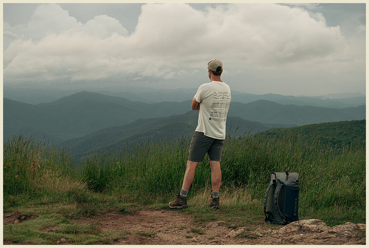 A Man standing on Black Balsam Knob and viewing the scenery