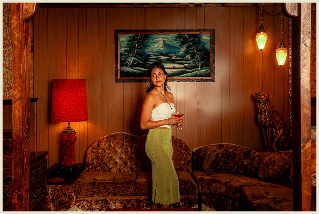 A woman holding a cocktail at a bar in Asheville, North Carolina.